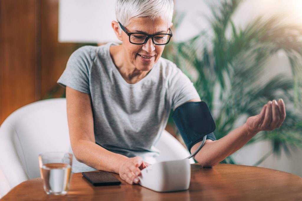 Woman using Blood Pressure Cuff